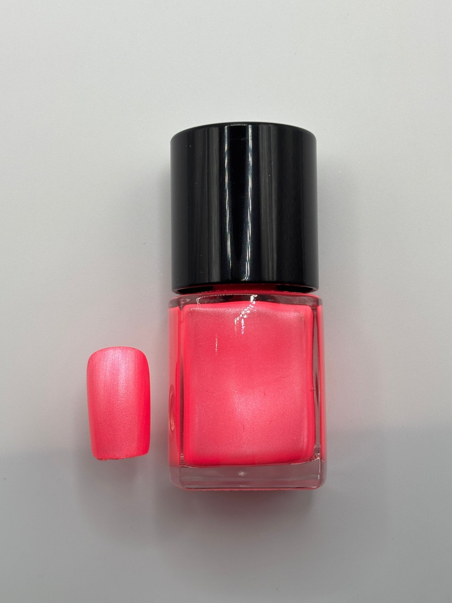 BOTTLE OF BRENDA WITH FINGERNAIL BESIDE IT