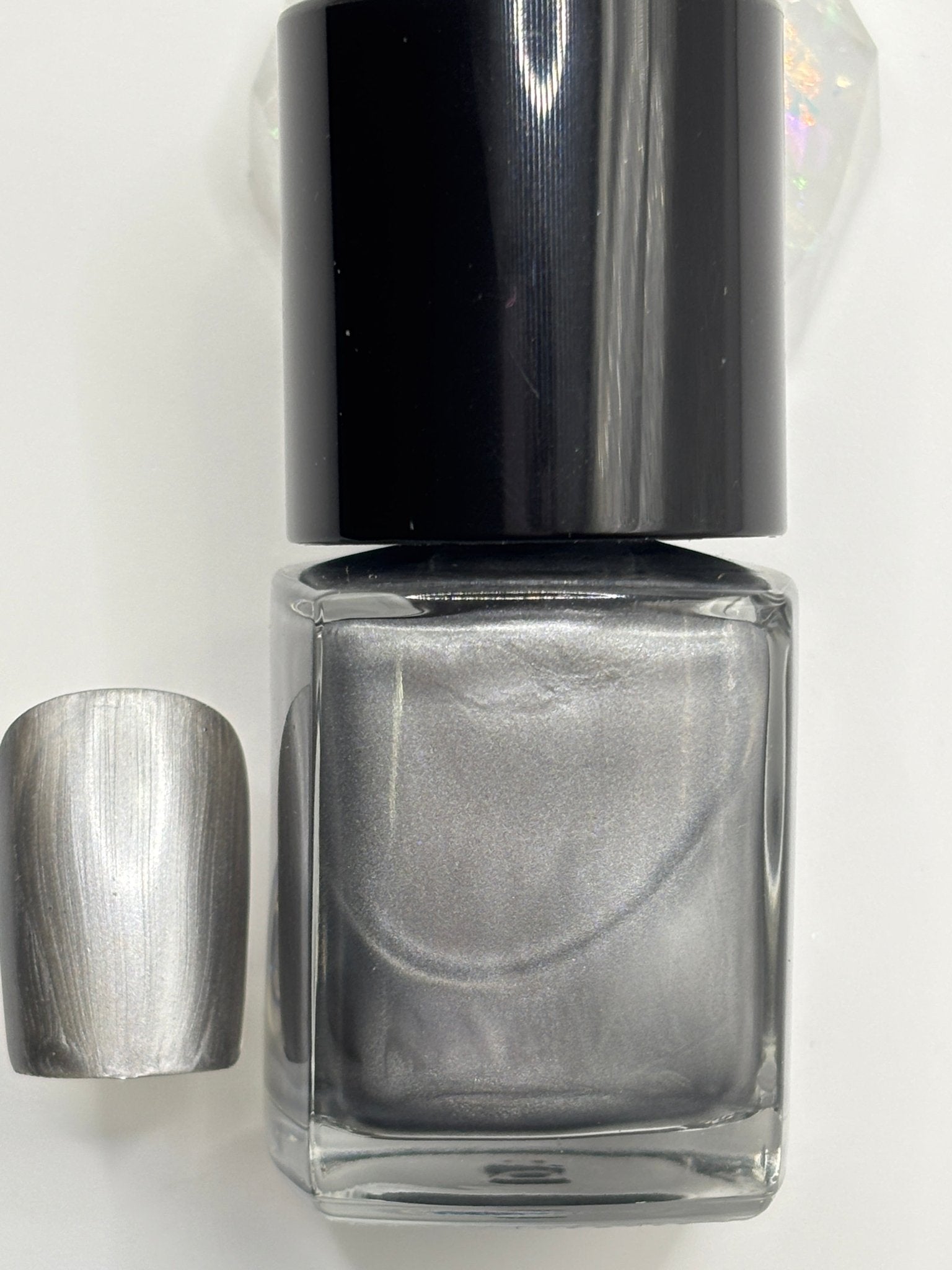 BOTTLE OF LYNIA AND A FAKE NAIL WITH THE COLOR OF LYNIA ON IT