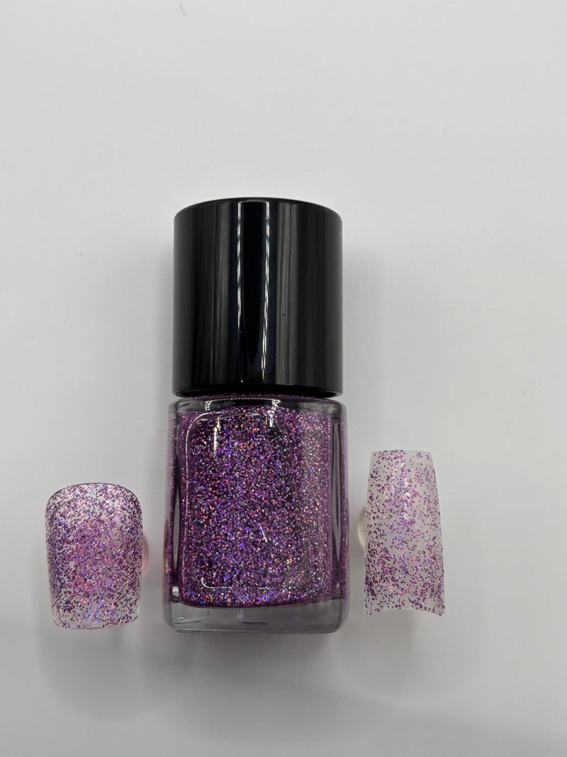 BOTTLE OF MASTER P. PURPLE GLITTER POLISH WITH 2 FINGERNAILS WITH THE POLISH ON THEM ON EACH SIDE OF THE BOTTLE