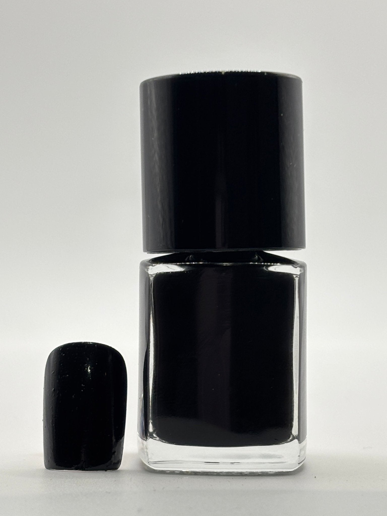 BOTTLE OF NALISA WITH FAKE NAIL BESIDE IT WITH THE SAME COLOR