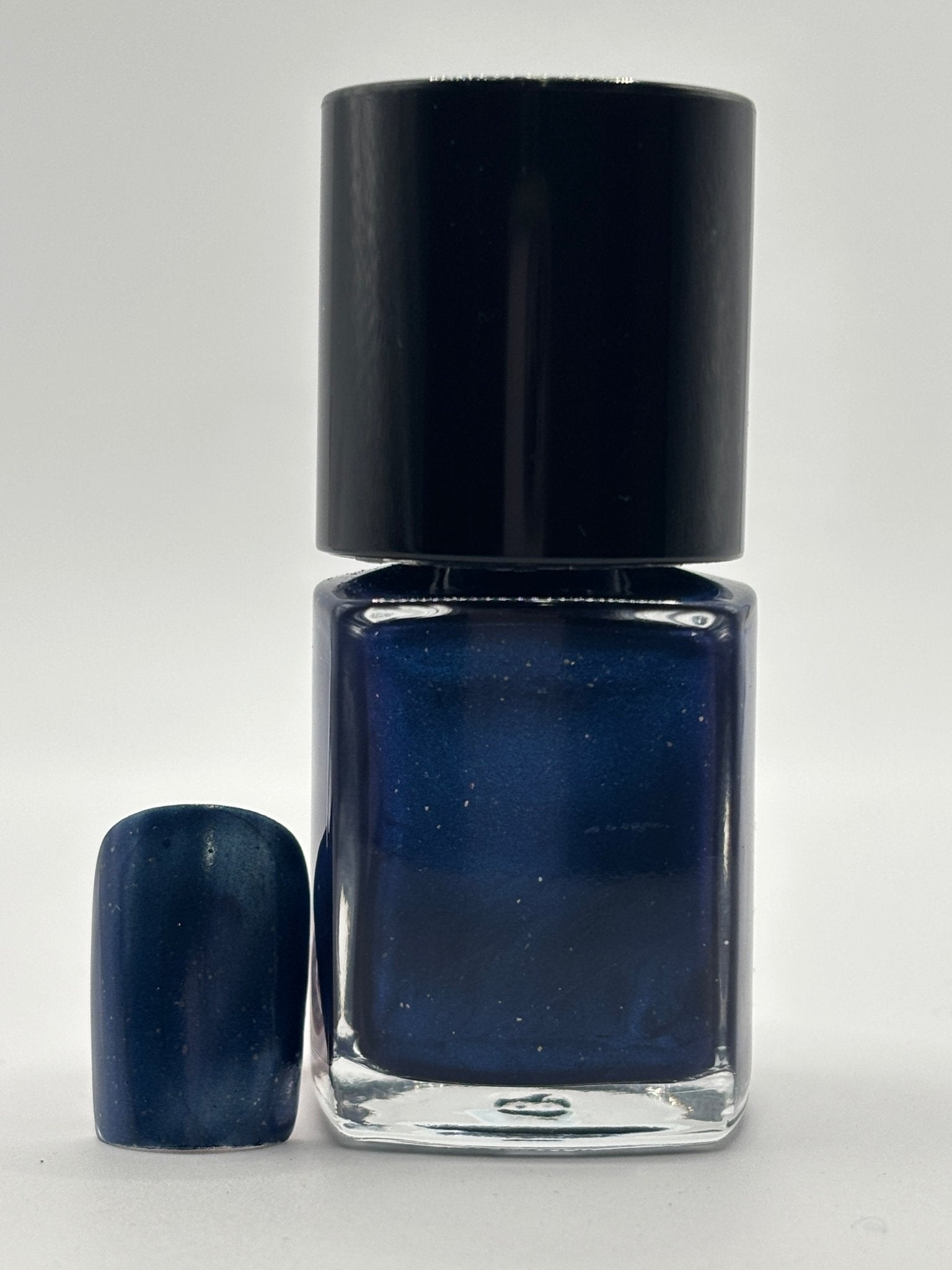 NIKKI 47 - BOTTLE WITH NIKKI AND A FAKE NAIL WITH NIKKI  ON IT SHIMMERING DARK BLUE