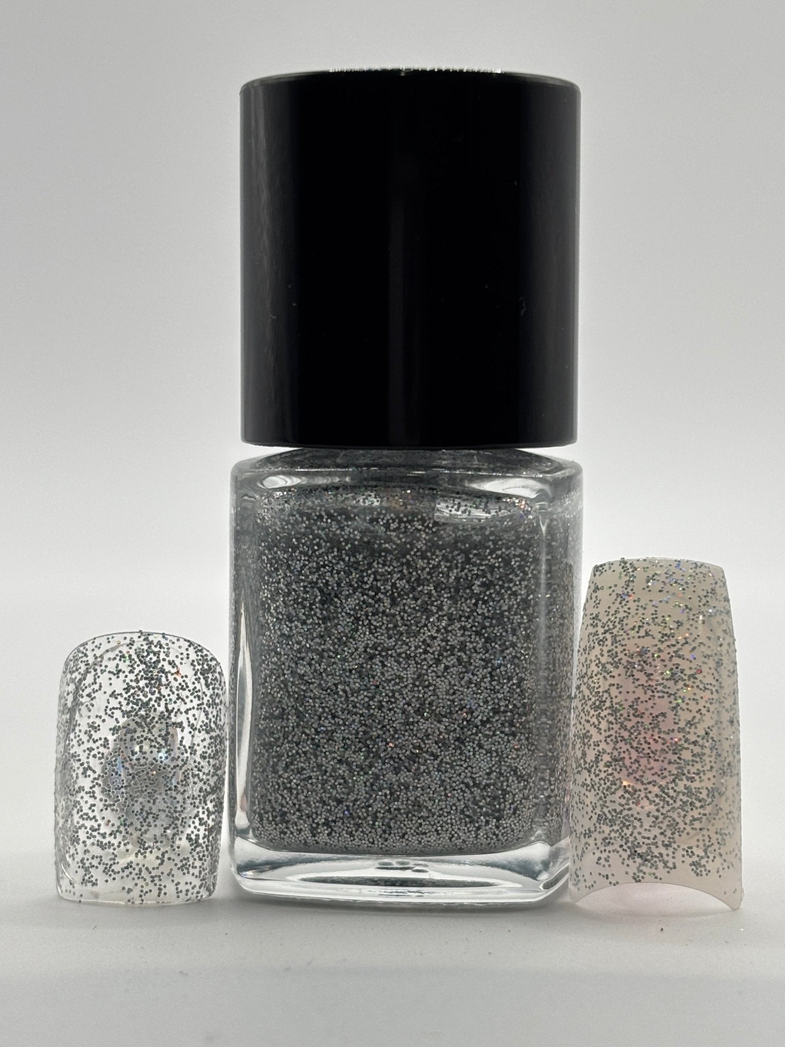 BOTTLE OF ROCHELLE WITH FAKE NAILS WITH THE GLITTER ON THEM ON BOTH SIDES OF THE BOTTLE