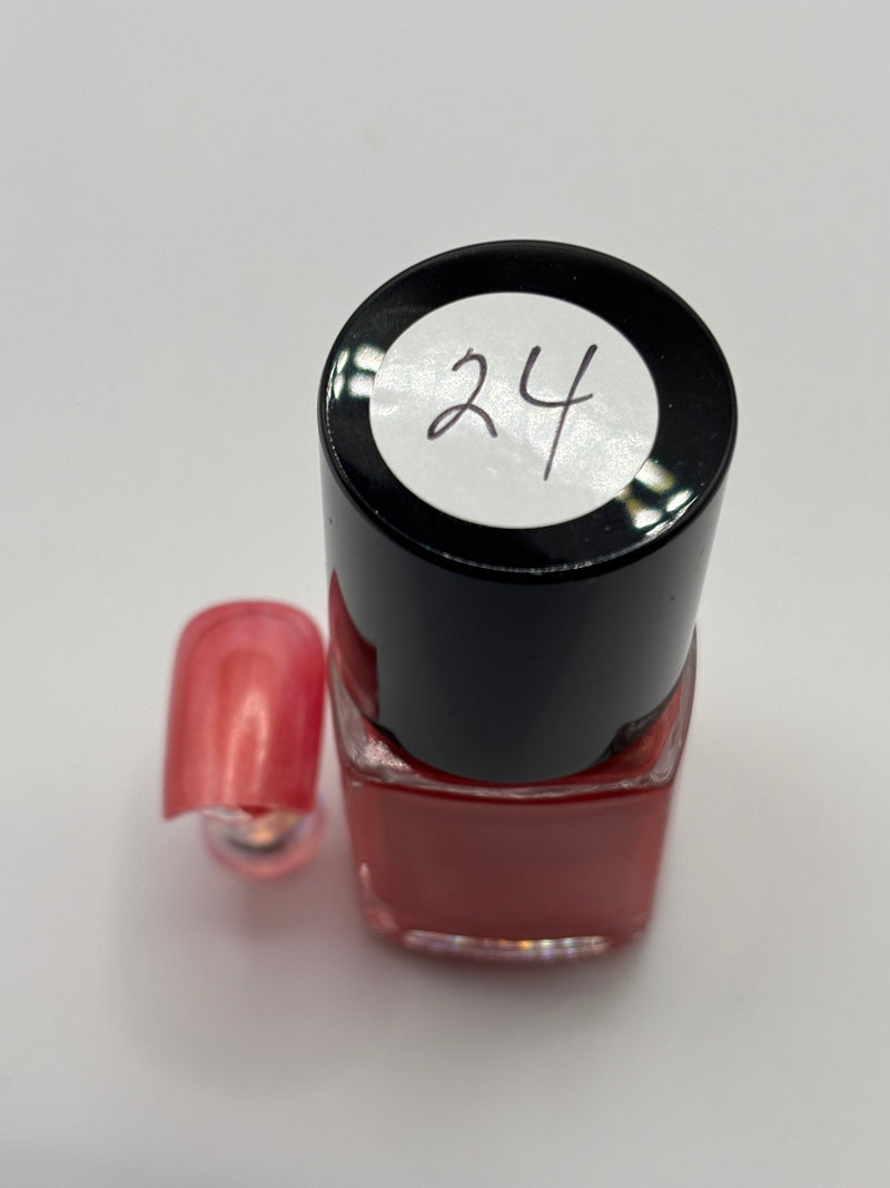bottle of Berniece and fake nail beside it with #24 on top of bottle