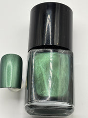 BOTTLE OF DR FRENCH WITH NAIL BESIDE THE BOTTLE WITH THE SAME COLOR AS THE BOTTLE