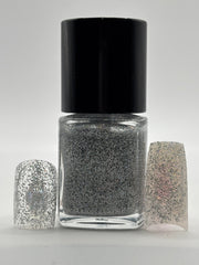 BOTTLE OF ROCHELLE WITH FAKE NAILS WITH THE GLITTER ON THEM ON BOTH SIDES OF THE BOTTLE