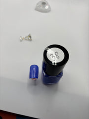 BOTTLE OF TIGE WITH A FAKE FINGERNAIL BESIDE IT THE SAME COLOR WITH THE NUMBER #37 ON THE TOP