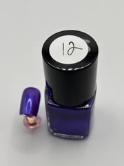 BOTTLE OF VALENCIA WITH NAIL BESIDE IT THE SAME COLOR WITH THE NUMBER 12 ON IT